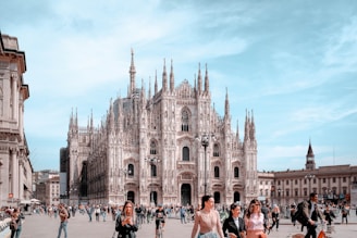 a group of people walking around a large cathedral