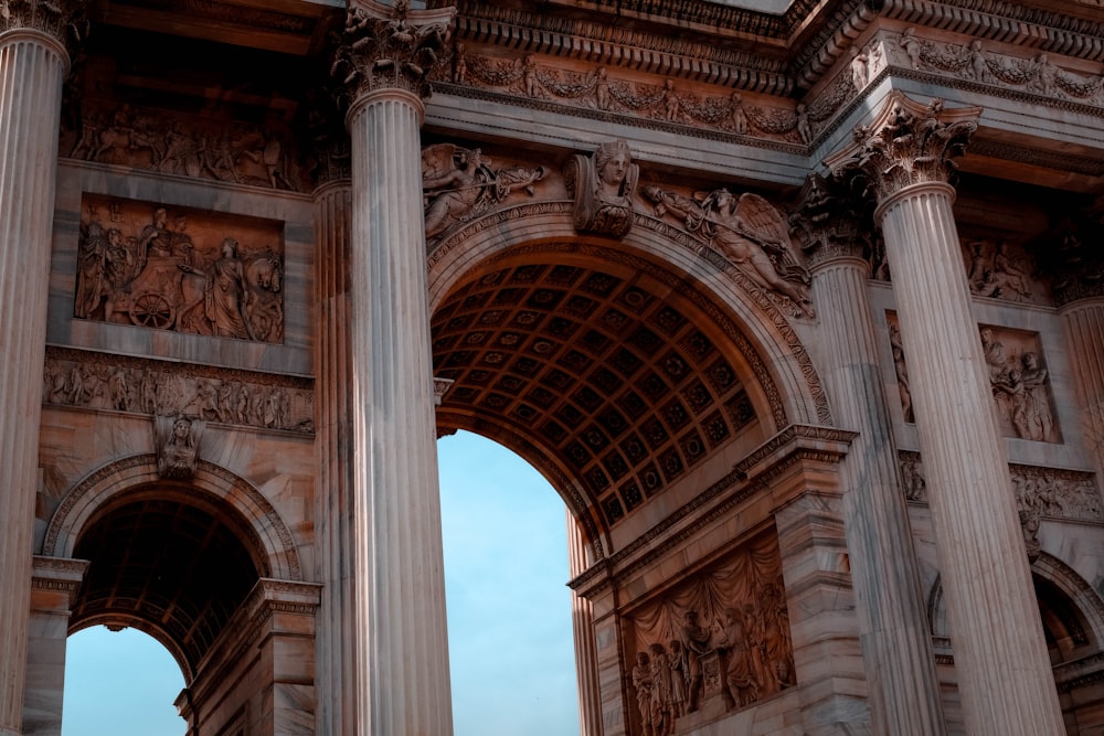 a stone arch with a clock on top of it