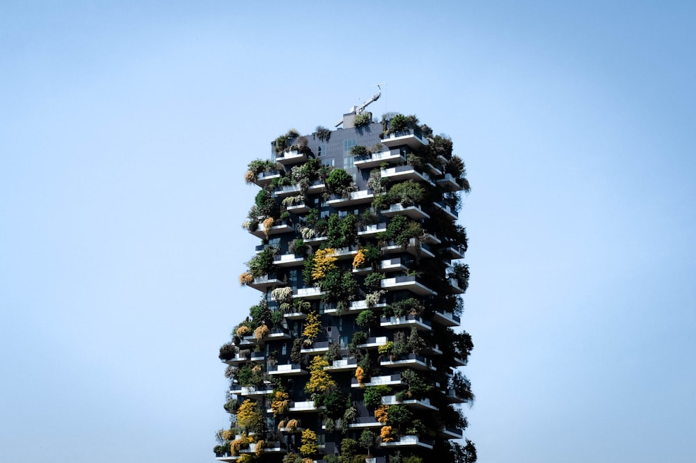 a very tall building with lots of plants growing on it