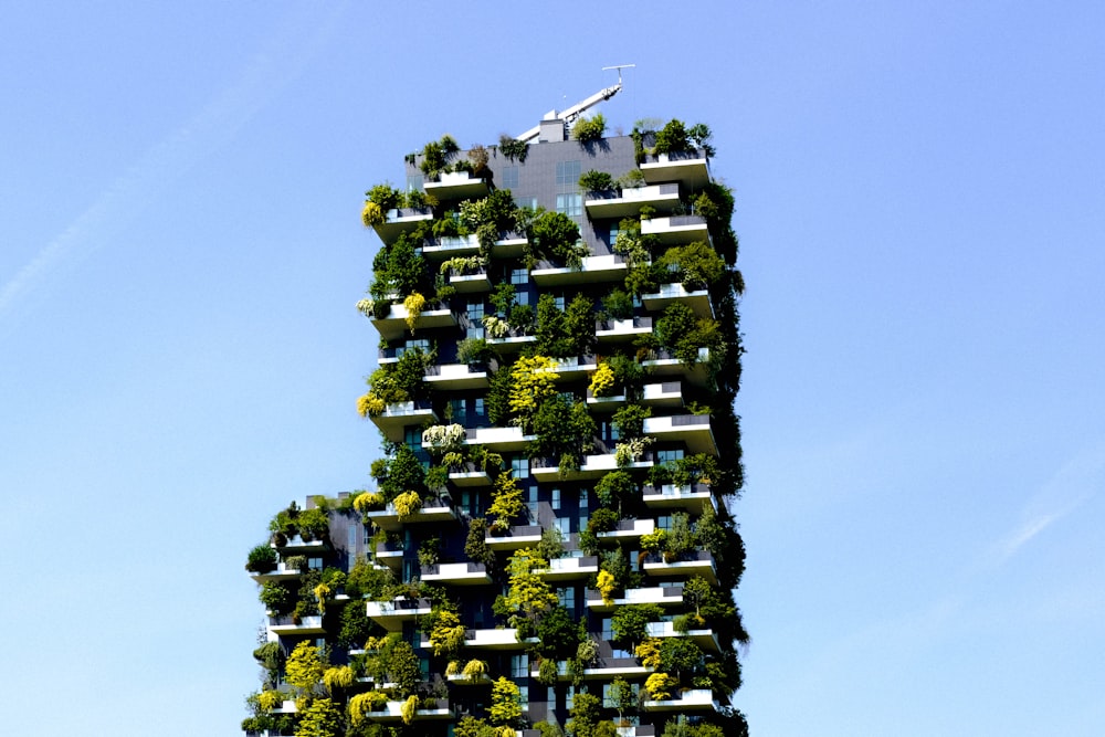 a very tall building with plants growing on it