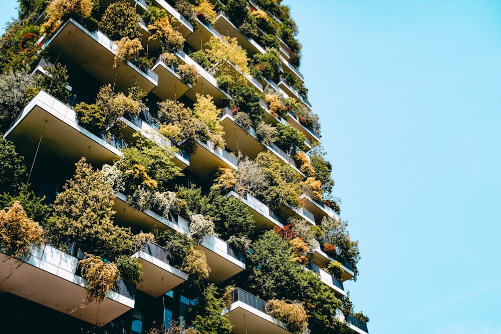 a very tall building with lots of plants growing on it