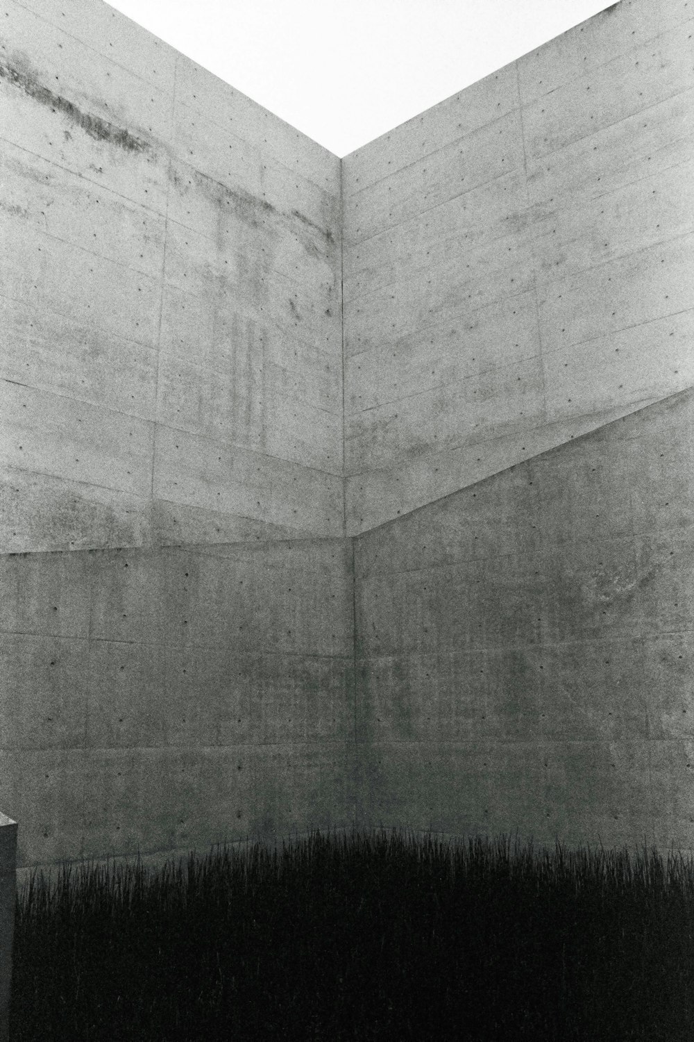 a black and white photo of a concrete wall