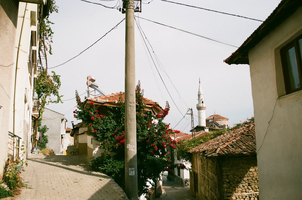 Una strada stretta con una torre dell'orologio sullo sfondo