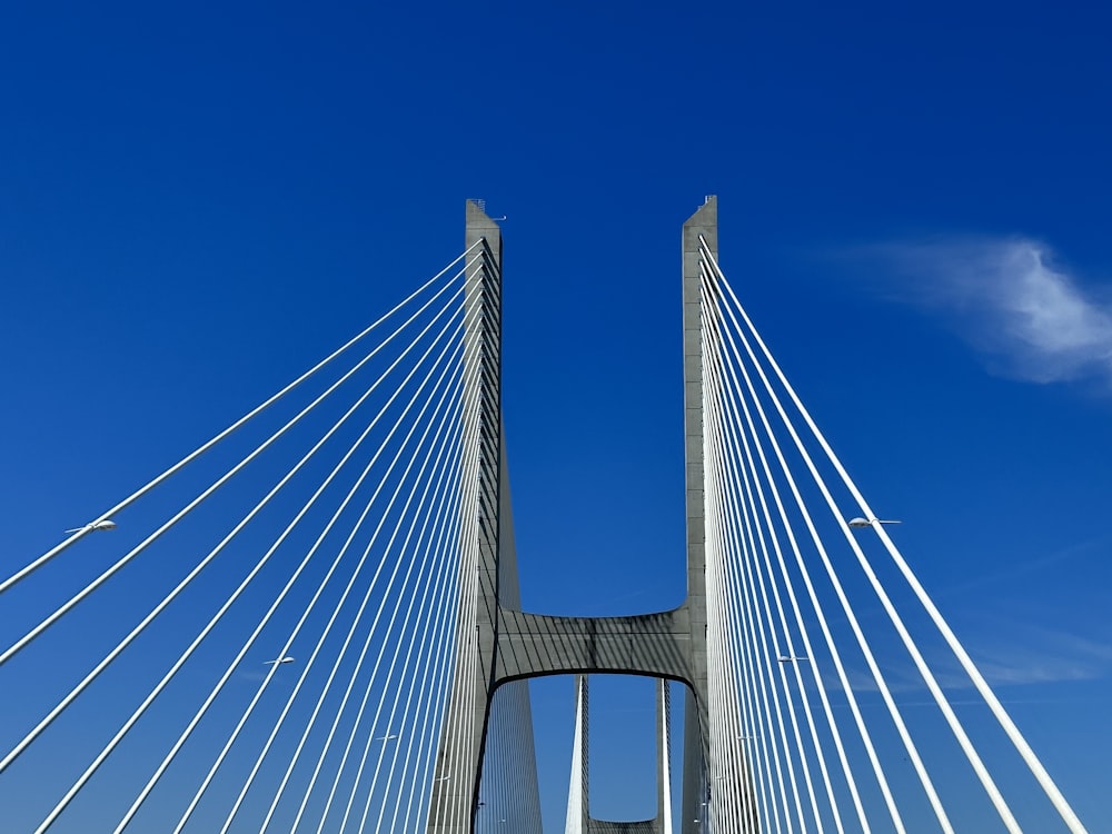 a very tall bridge with a plane flying over it