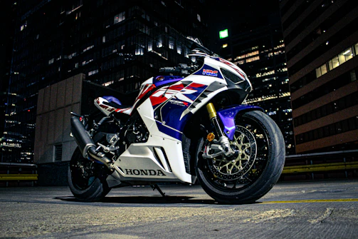 A classic Honda cruiser motorcycle shining under city lights at night