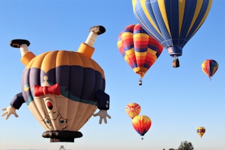 a number of hot air balloons flying in the sky