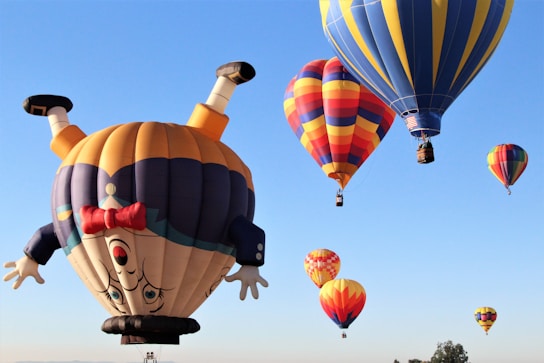 a number of hot air balloons flying in the sky