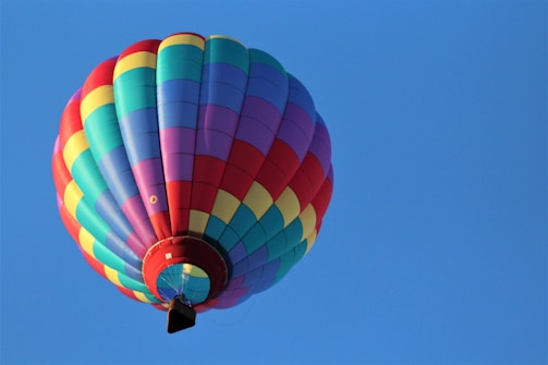 A colorful hydro rocket soaring against a clear blue sky.