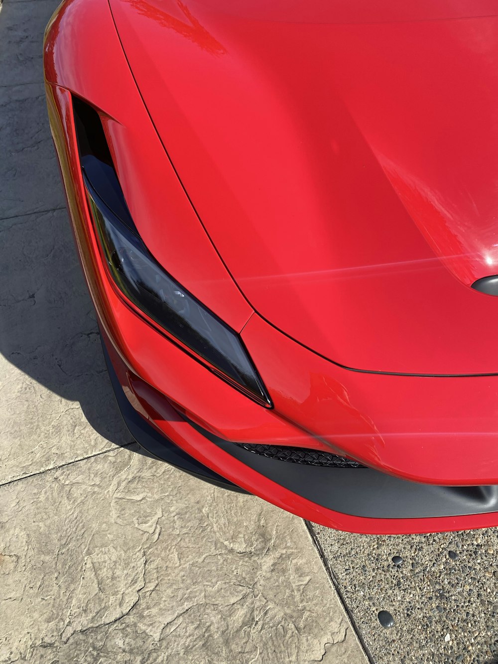 a red sports car parked on the side of the road