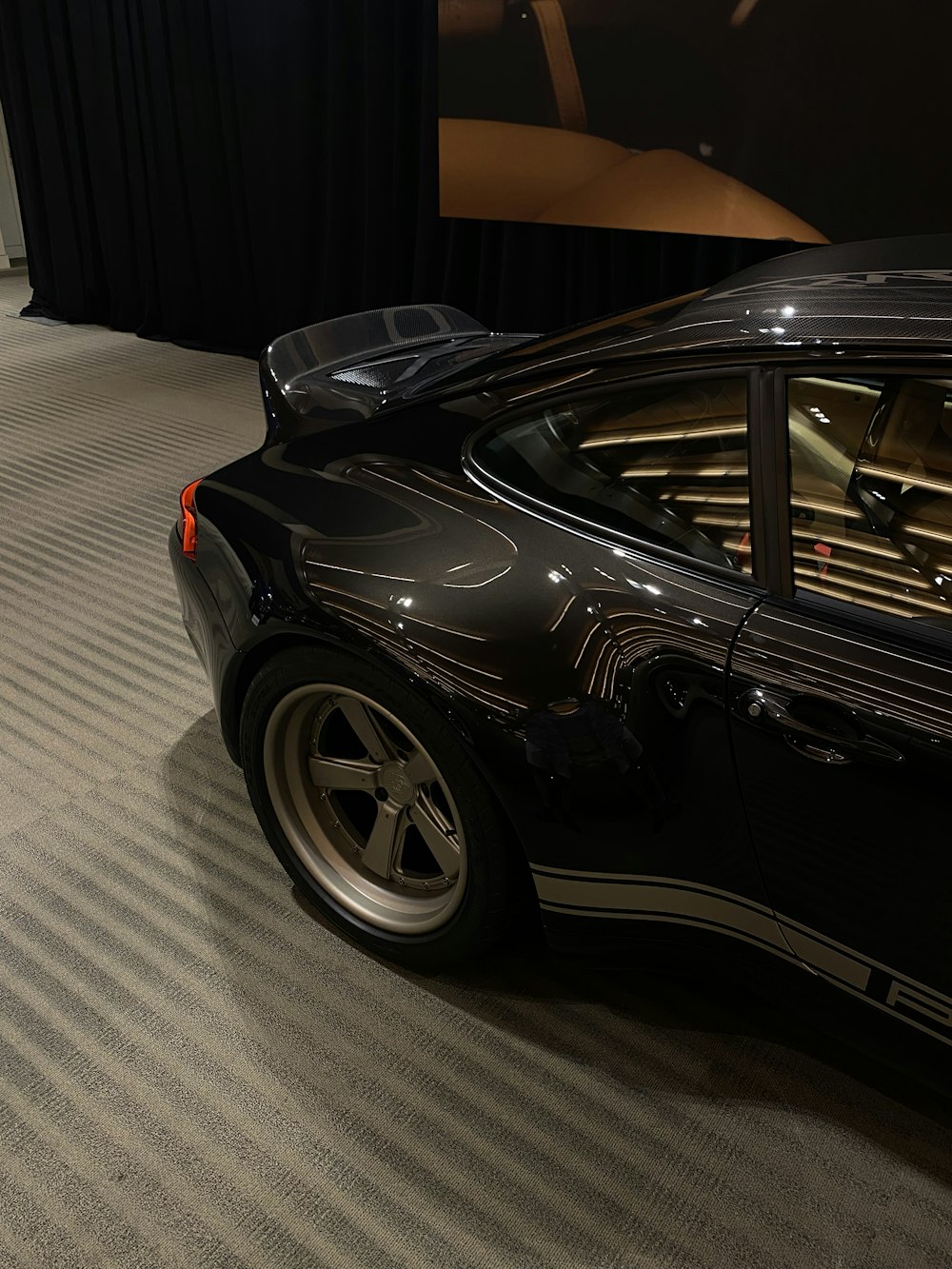 a black sports car parked in a showroom