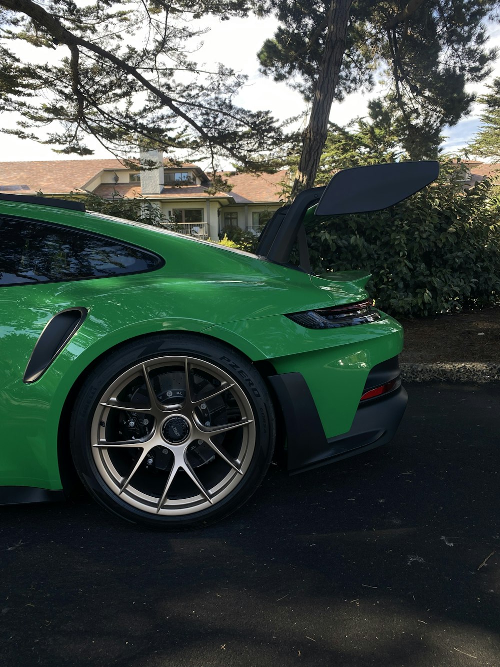 a green sports car parked in a driveway