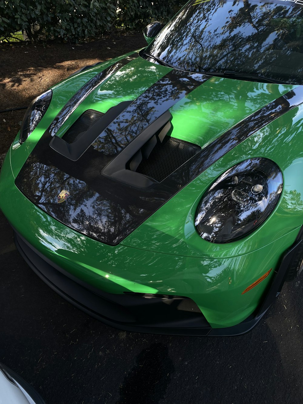 a green sports car parked on the side of the road