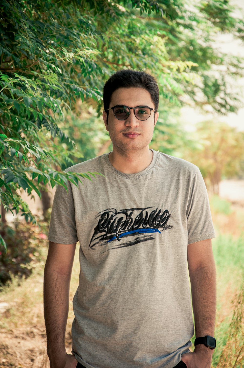 a man standing in front of a tree