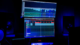 A bustling newsroom with journalists working on computers and large screens showing live news feeds