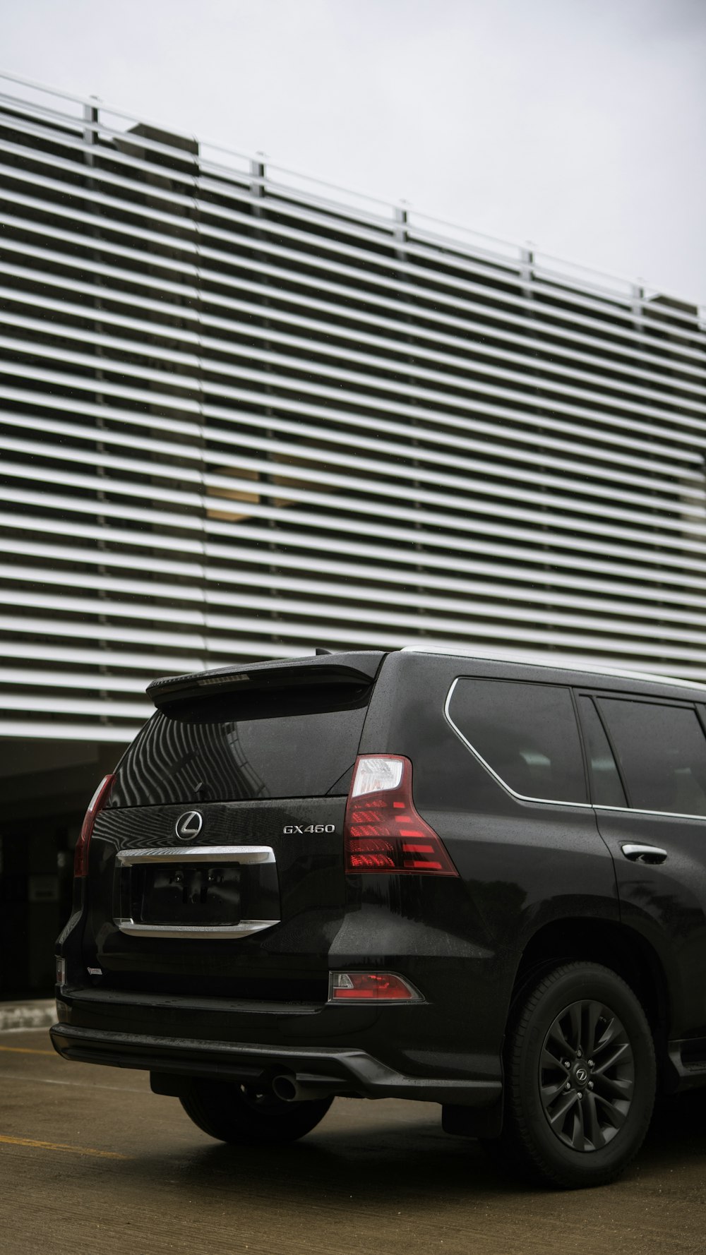 a black suv parked in front of a building
