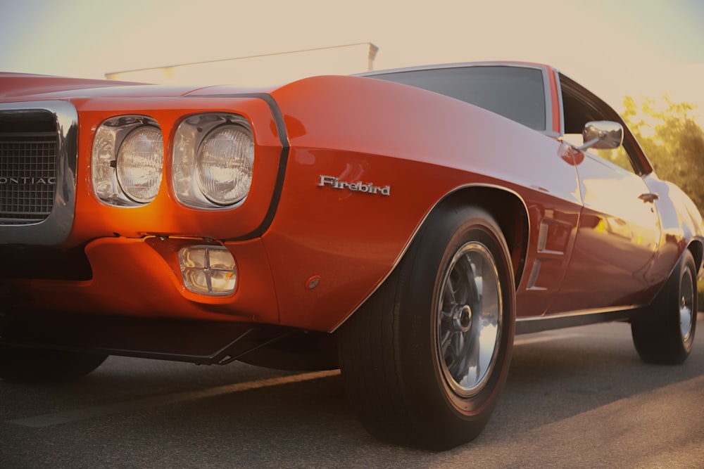 a close up of a red car on a road