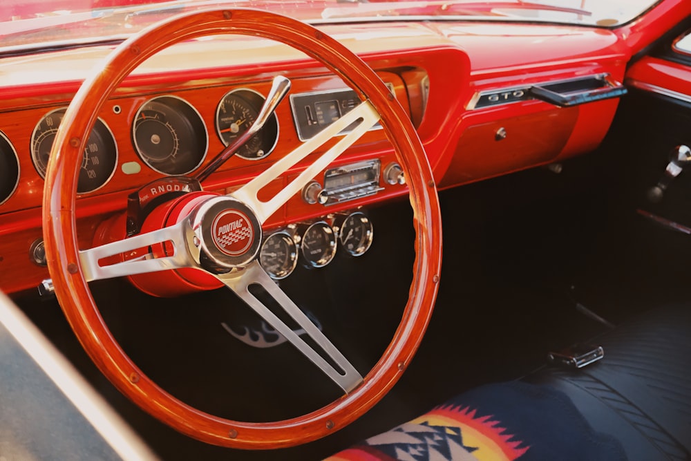 a car dashboard with a steering wheel and gauges