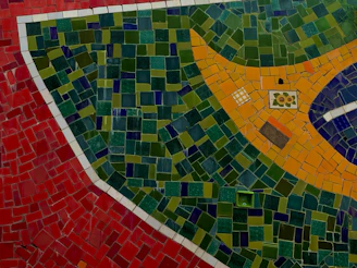 Vibrant mosaic art piece showcasing intricate patterns and rich colors in a sunlit room.