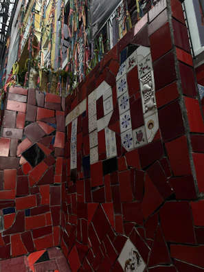 An outdoor patio wall with colorful mosaic tiles creating a vibrant backdrop.