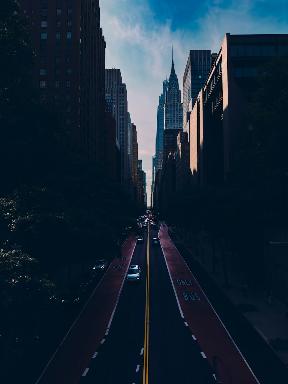 a city street with tall buildings in the background