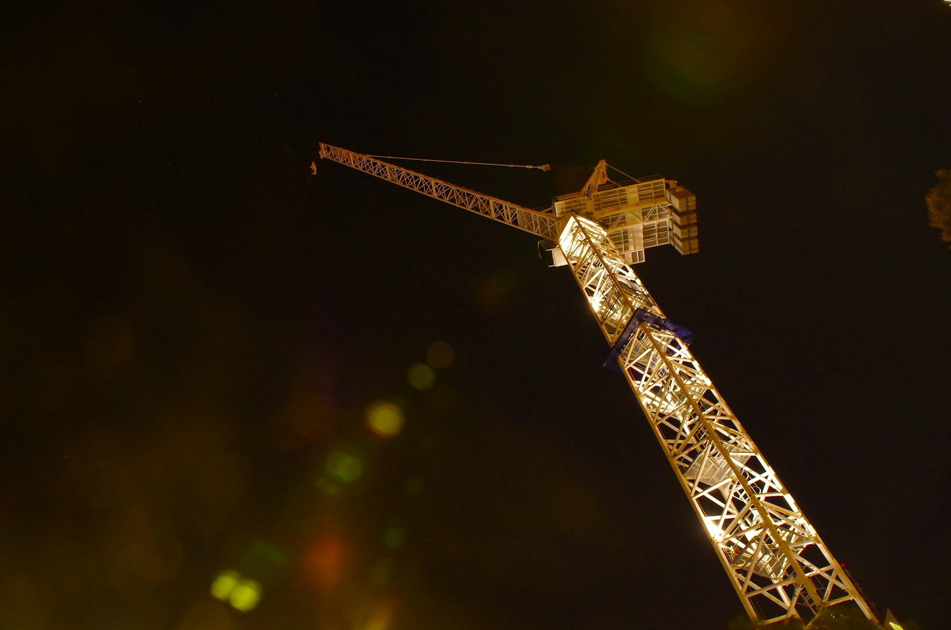 a very tall tower with a crane on top of it