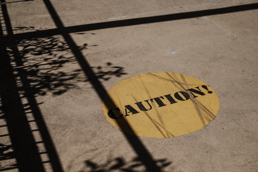 a yellow caution sign sitting on the side of a road