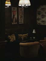 A warmly lit lounge area showcasing paintings inspired by regional history.