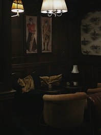 Cozy and dimly lit love room inside the Donjon de Touraine with medieval decor and plush seating.