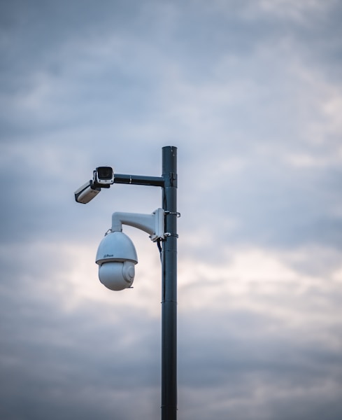 a street light with a camera attached to it