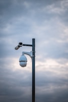 a street light with a camera attached to it