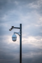 a street light with a camera attached to it