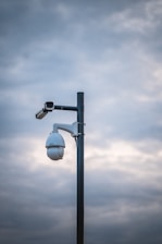 a street light with a camera attached to it