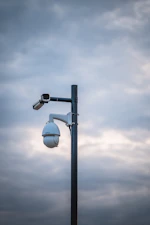 a street light with a camera attached to it