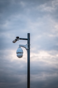 a street light with a camera attached to it