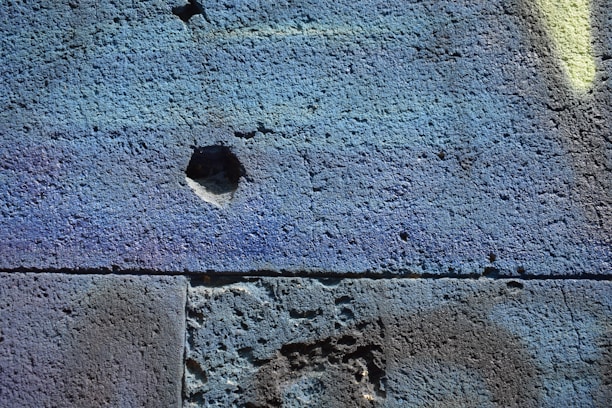 Photo showing a modern interior wall with smooth cement finish and vibrant custom colors.