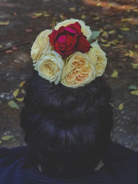 Elegant low bun hairstyle adorned with jasmine flowers and golden accessories.