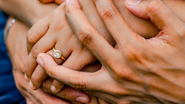 a close up of a person holding another person's hand