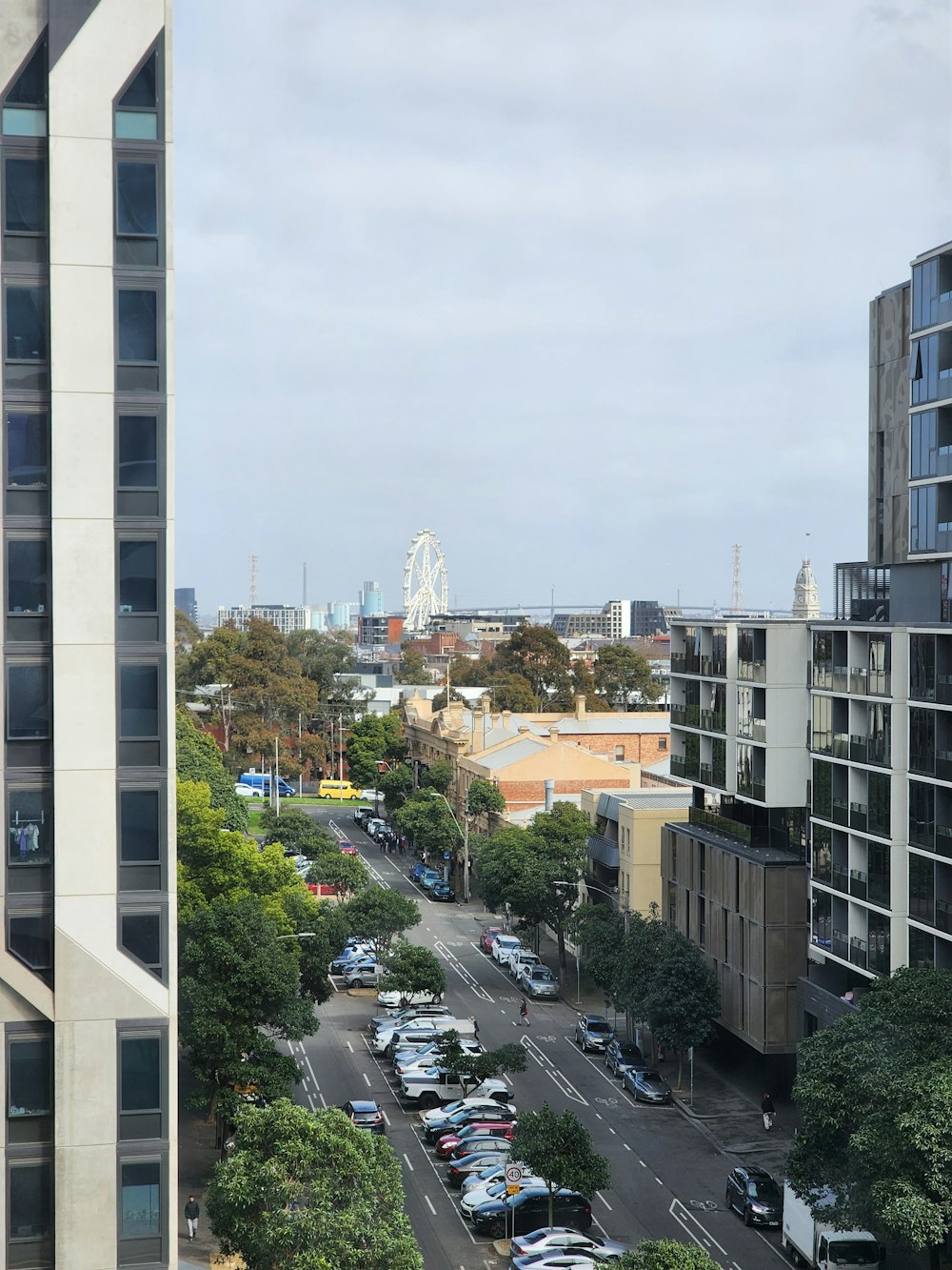 a city street filled with lots of traffic next to tall buildings