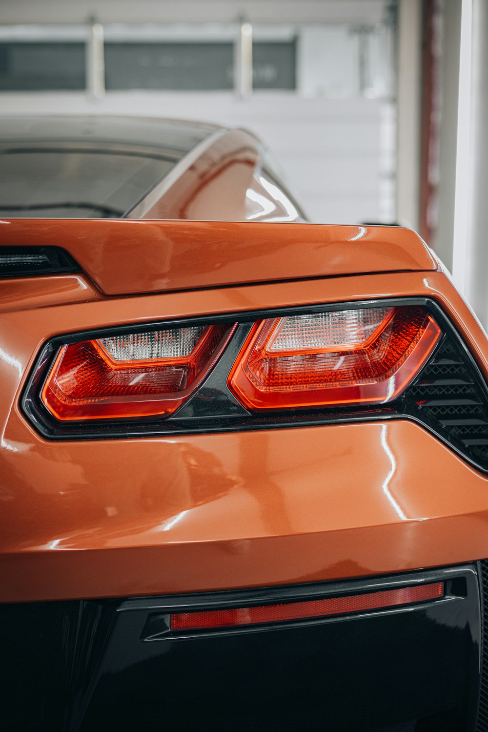 an orange sports car parked in a garage