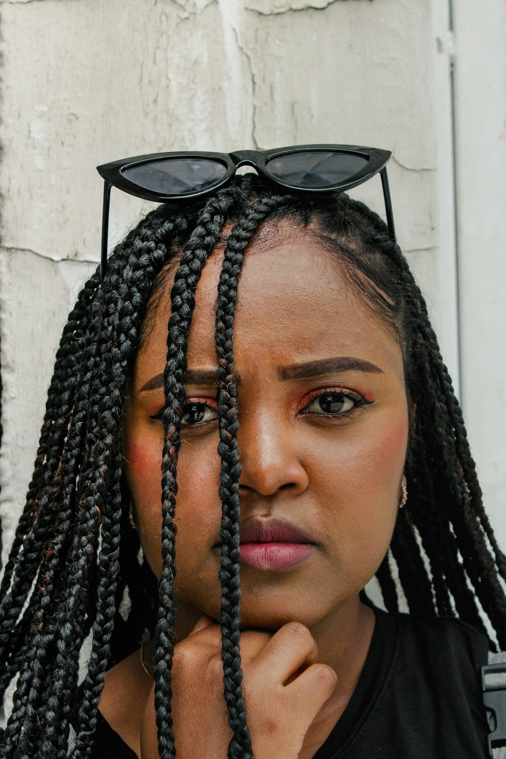 a woman with a pair of sunglasses on her head