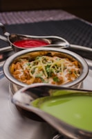 Premium product shot of assorted frozen Indian gravies in sleek packaging with icy blue accents.