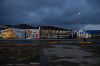 A gritty street art mural on a brick wall in Hamburg’s Sternschanze district under moody evening light.