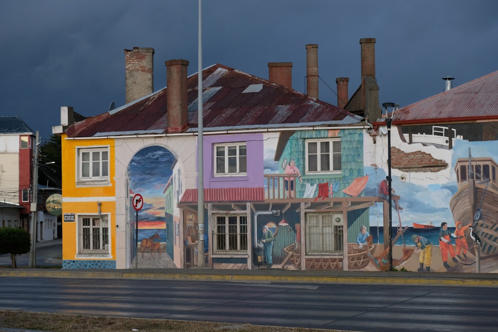 a row of colorful houses painted on the side of a building