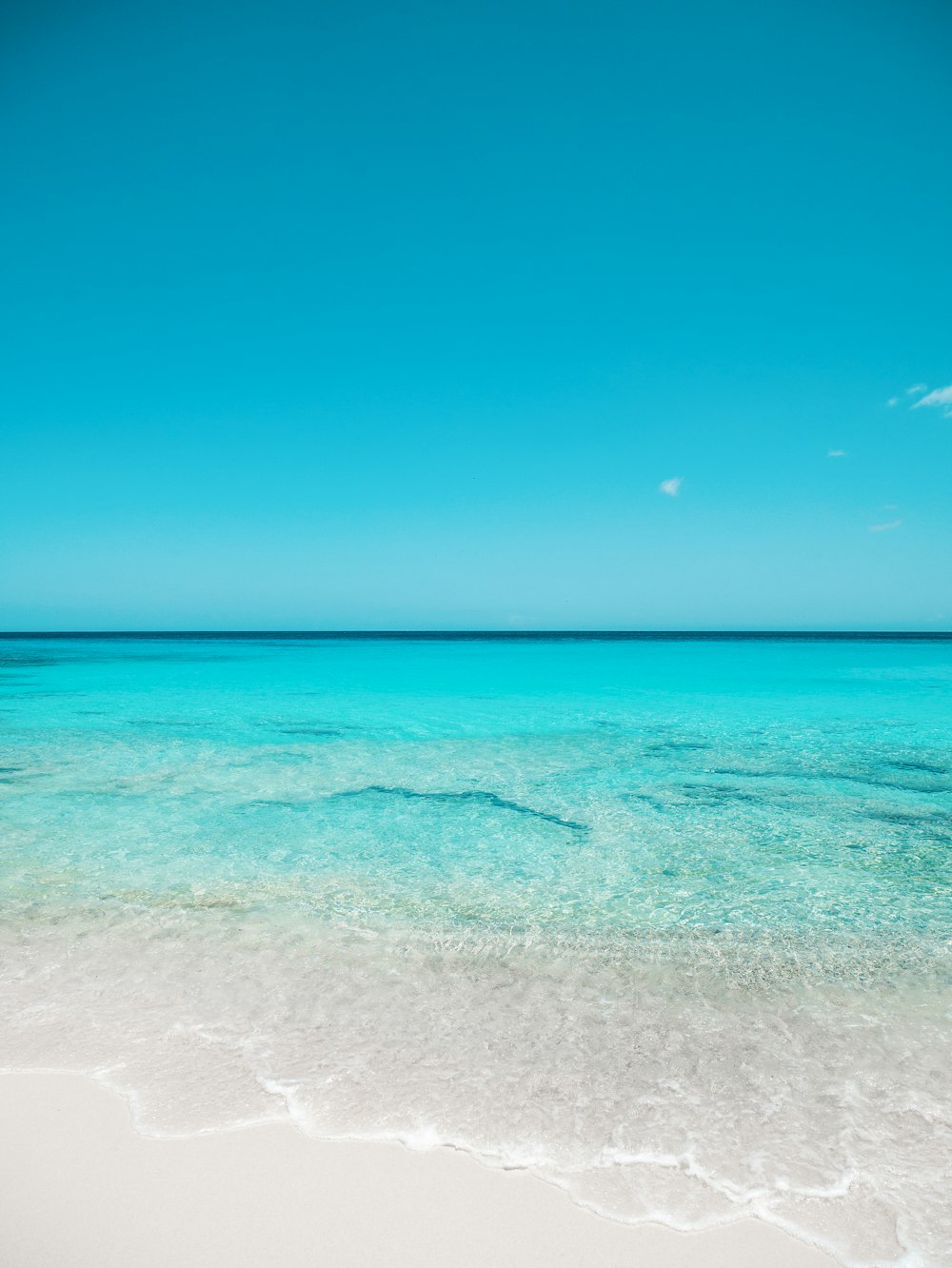 a view of the ocean from a sandy beach