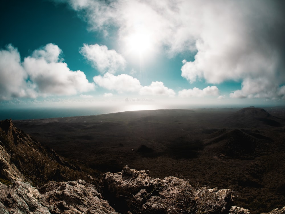 the sun shines brightly over a mountain range