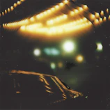 A dreamy video still showing shimmering light over textured collage art.