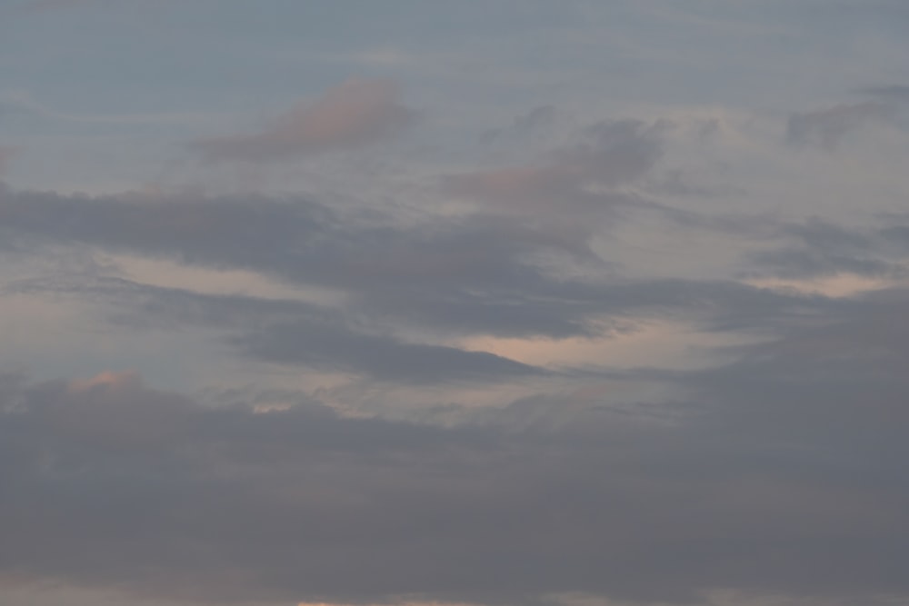 a plane flying through a cloudy sky with no clouds