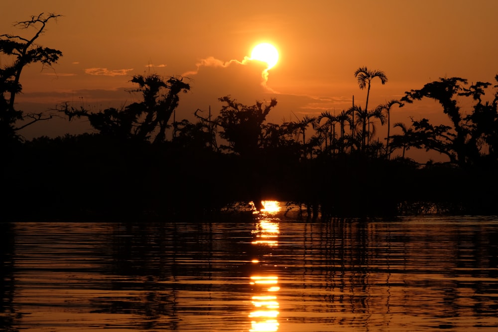 the sun is setting over a body of water