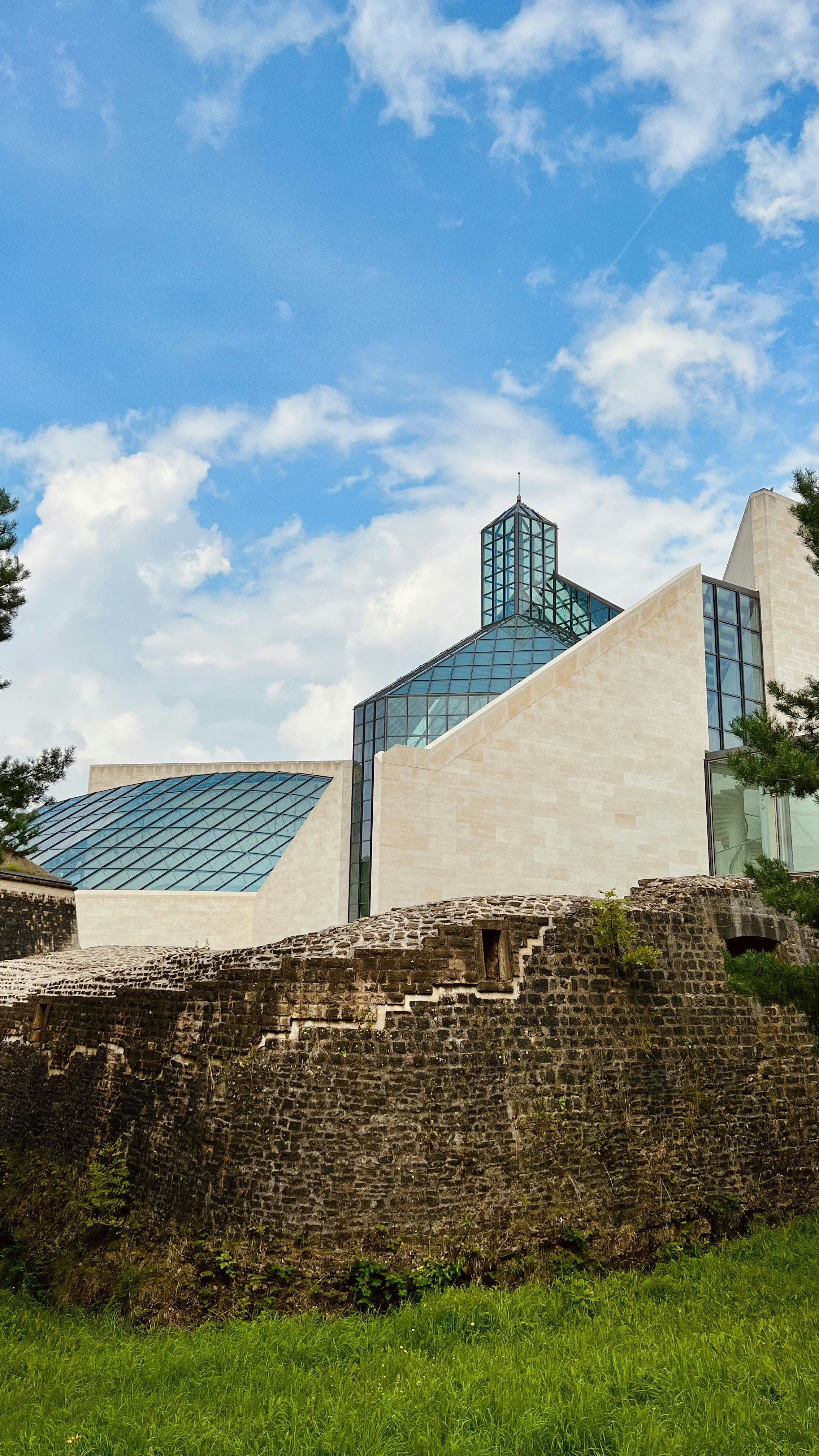 a very tall building sitting on top of a lush green field