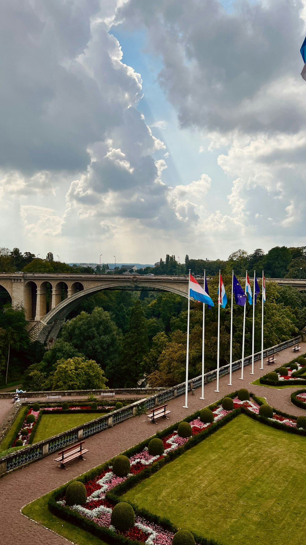 a view of a park with a bridge in the background